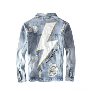 Large lightning bolt graphic print on back of distressed denim jacket with frayed edges