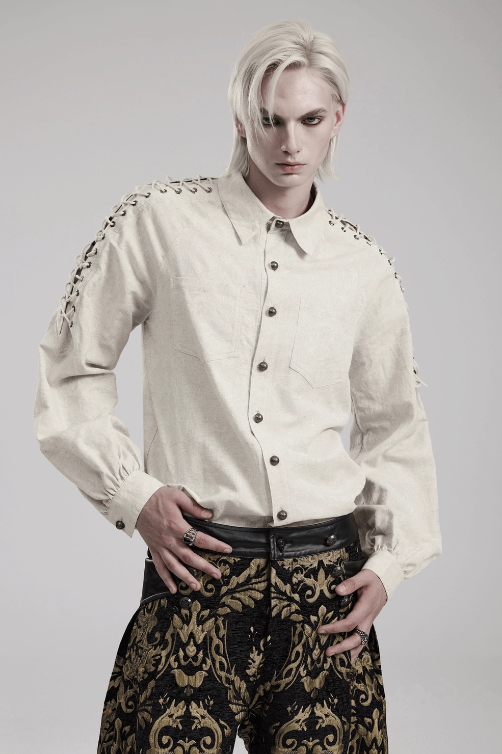 Full body shot of model in gothic linen shirt with eyelet chain shoulders - studio photography on white