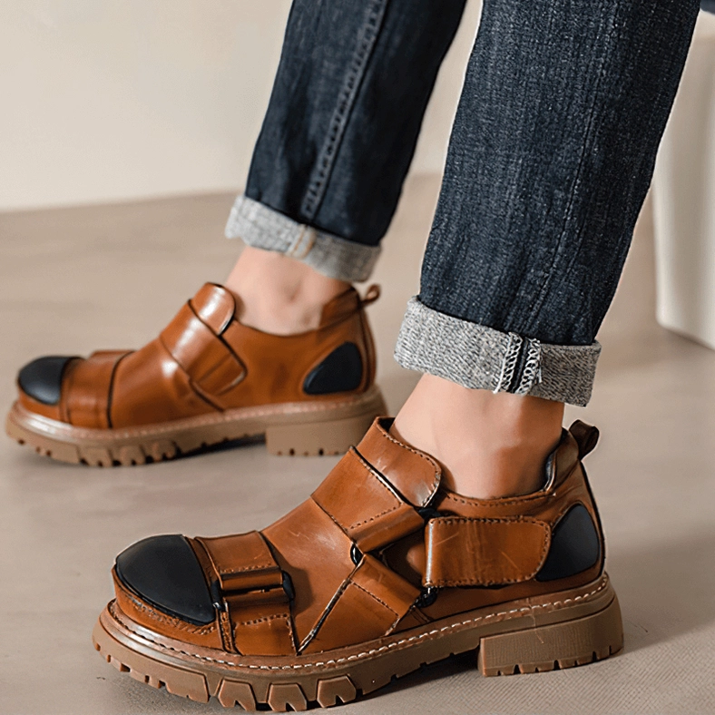 Gothic platform loafers detail shot showing velcro strap hardware and leather texture, close-up view