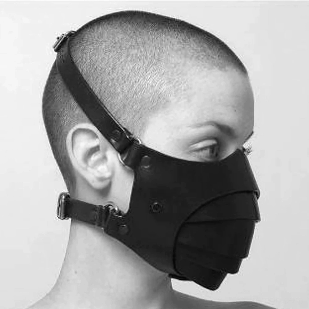 Gothic unisex face mask detail shot emphasizing intricate leather layering and metal D-ring fasteners
