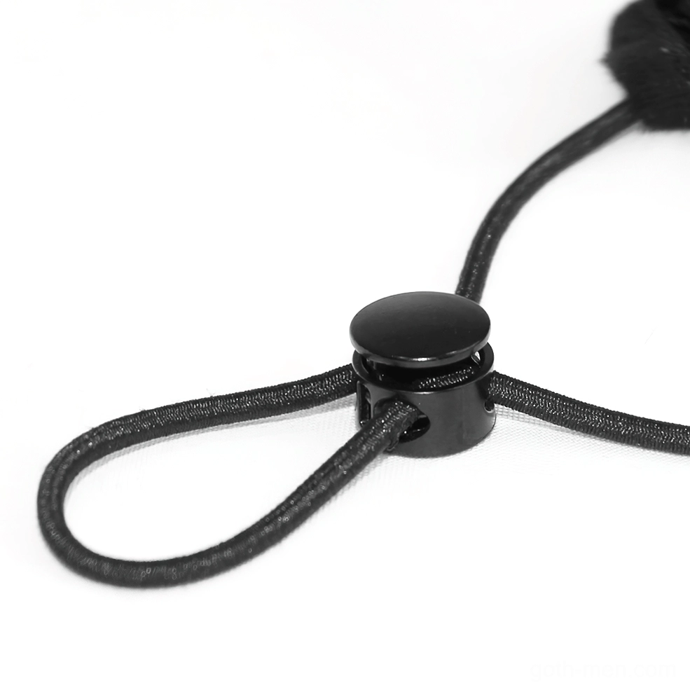 Close-up macro shot of gothic mask ear loop adjuster featuring black plastic cord lock for adjustable fit