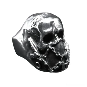 Aged silver finish memento mori skull ring showcasing detailed bone carving and weathered metal texture, side profile