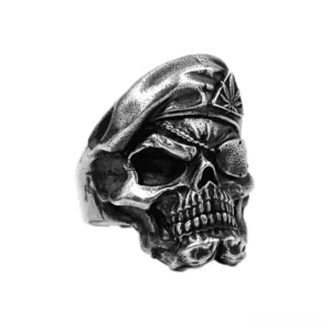 Sterling silver skull ring three-quarter front view showing detailed skull face with oxidized patina finish and textured band