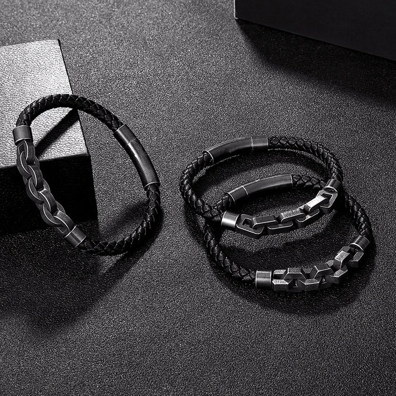 Flat lay collection of three men's gothic leather bracelets in black showing all design variations with gunmetal finishes