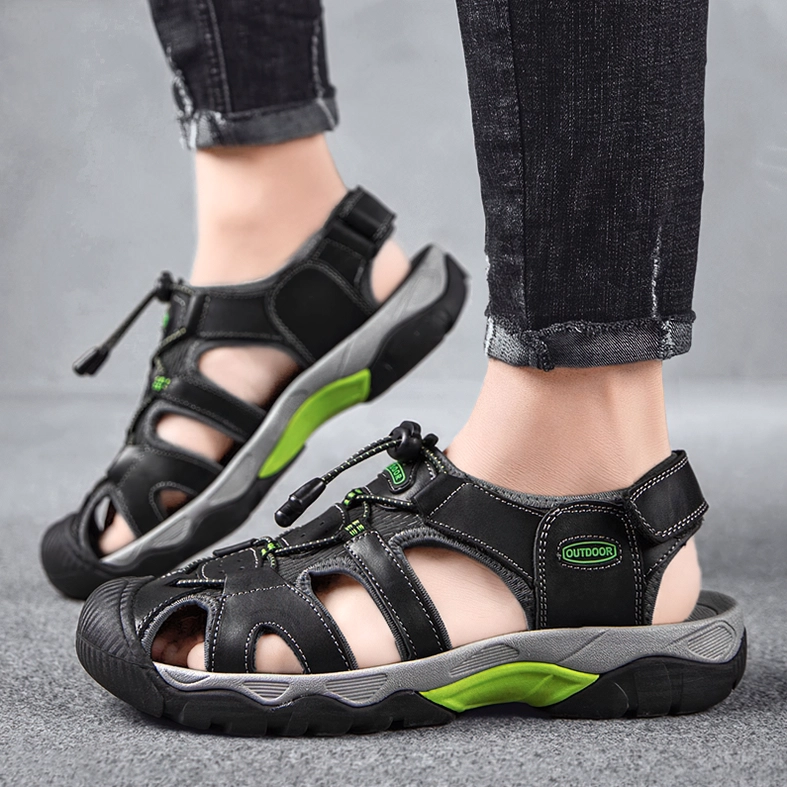 Model wearing black and grey gothic men's sandals with denim pants ankle top-down view