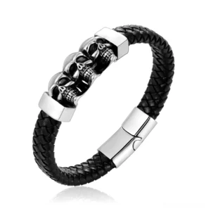 Black woven genuine leather skull bracelet with three silver skull charms and magnetic clasp, front angled view on white background