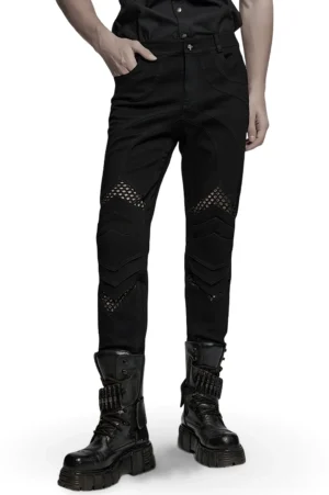 Black gothic mesh knee pants with 3D architectural knee pieces worn by male model, front three-quarter view showing fitted silhouette and fishnet cutout details