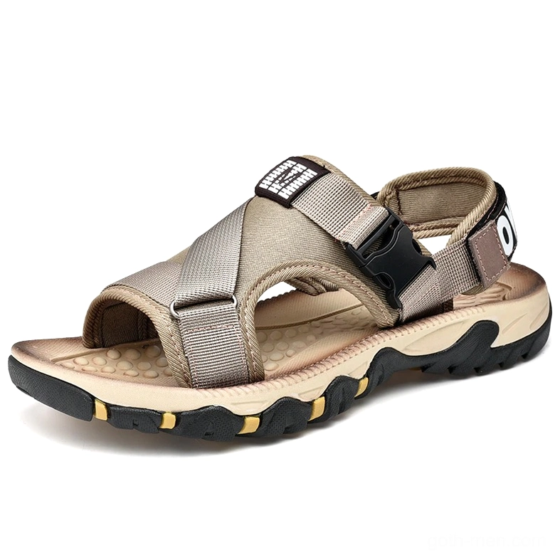 Khaki gothic buckle sandals with cross strap configuration and adjustable closure mechanism