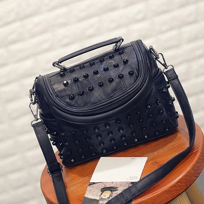 Black studded messenger bag front view showcasing compartments and functional design features