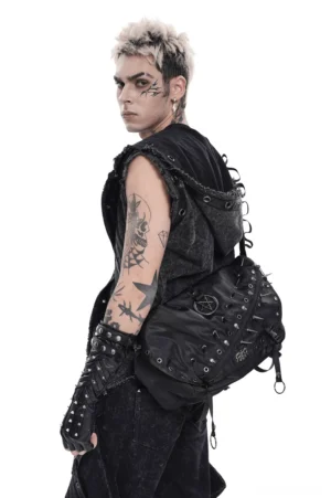 Tattooed male model wearing black pentagram studded gothic messenger bag, rear three-quarter view showcasing spike details and strap adjustment