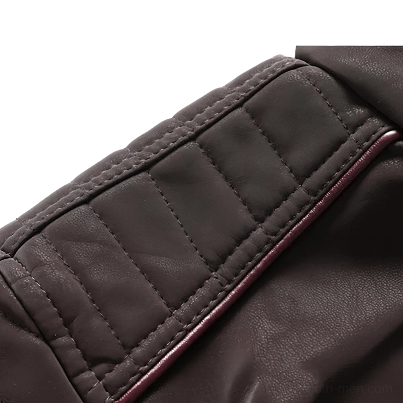 Close-up detail of red trim quilted leather paneling on gothic motorcycle jacket with horizontal stitching pattern
