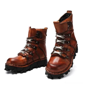 Vintage brown genuine leather gothic motorcycle boots three-quarter front view with metal lace hardware and chunky rugged rubber outsole
