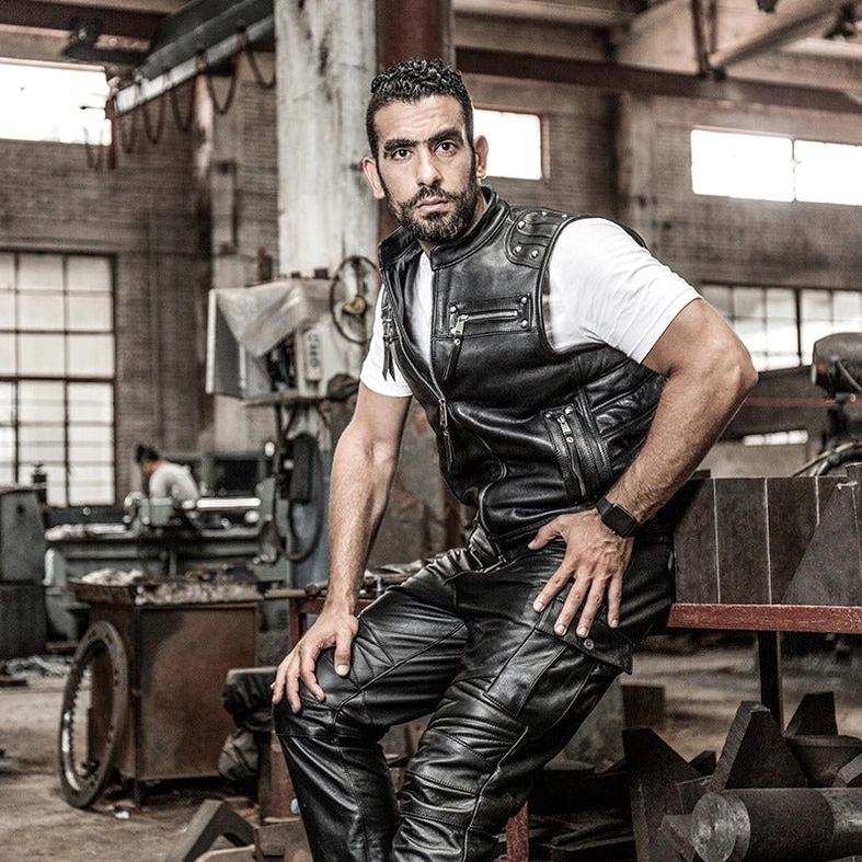 Tailored fit demonstration of black genuine leather biker vest in studio setting