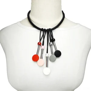 Multicolor beaded gothic silicone choker on female mannequin, front close-up view showing black elastic rope with dangling matte bead pendants in mixed colors