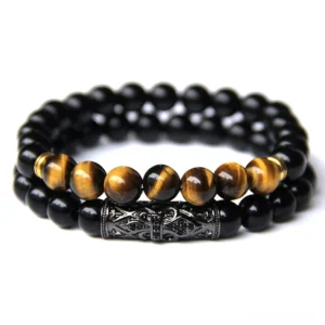 Gothic beaded bracelet featuring tiger's eye and matte black stone beads with carved metal ornamental detailing