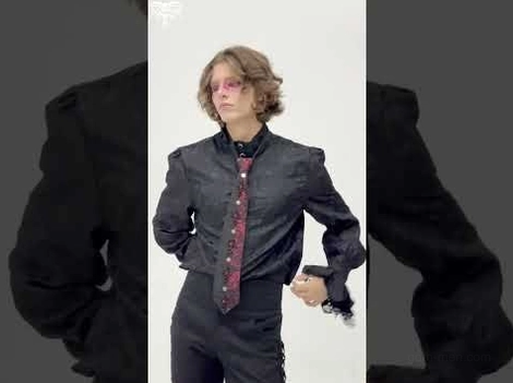 Slim cut gothic necktie paired with formal dress shirt, side back view detail on male model