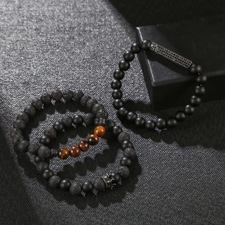 Unisex black onyx beaded gothic bracelet displayed with luxury jewelry box, engraved metal accents and crown decoration, flat lay styling