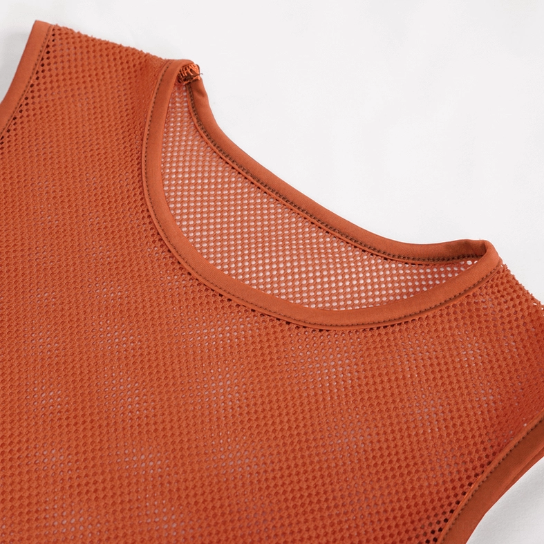 Orange mesh tank top fabric detail - 100% polyamide transparent knit showing texture