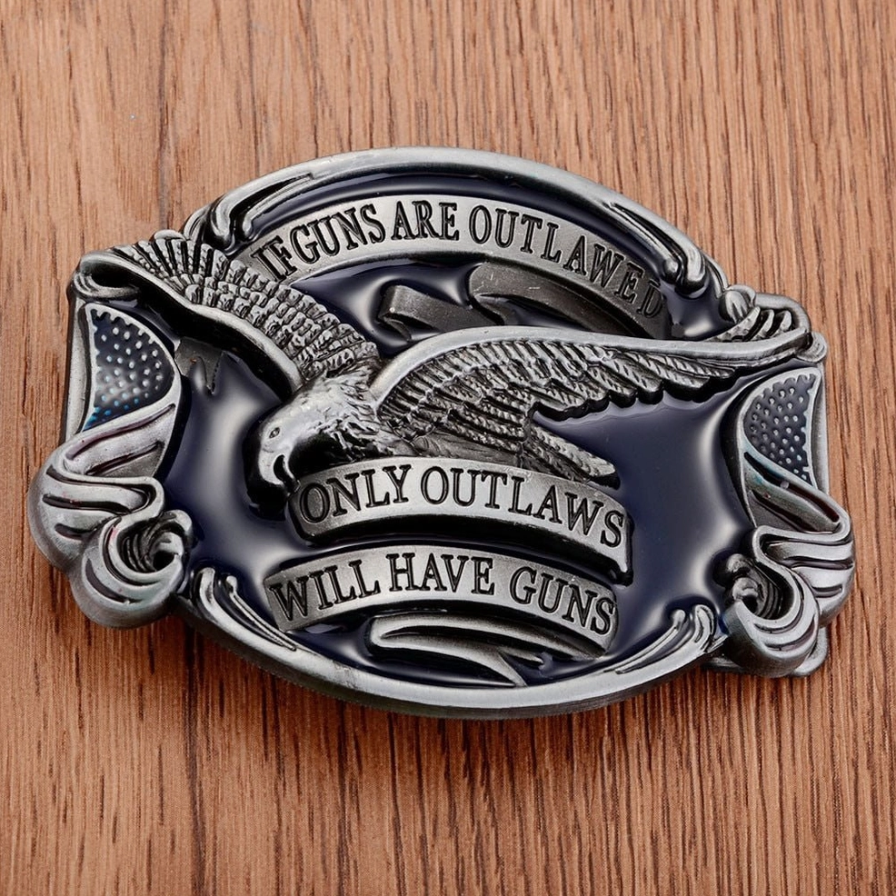 Outlaw eagle gothic belt buckle displayed on wooden texture background showing antique silver with black enamel details