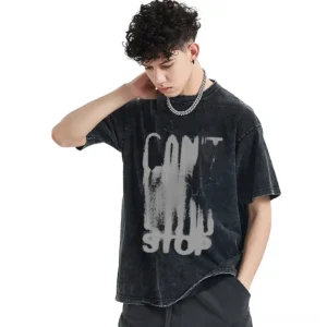 Male model wearing oversized black distressed cotton graphic t-shirt with CAN'T STOP letter print, three-quarter view angle