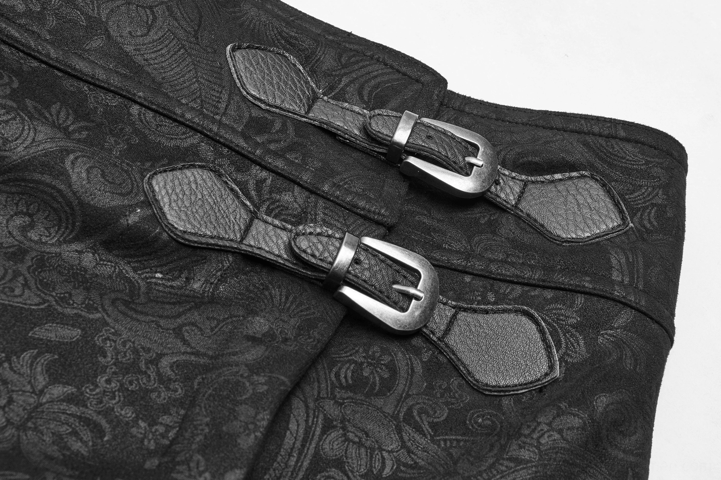 Detailed view of gothic overskirt buckle straps and metal hardware on leather trim