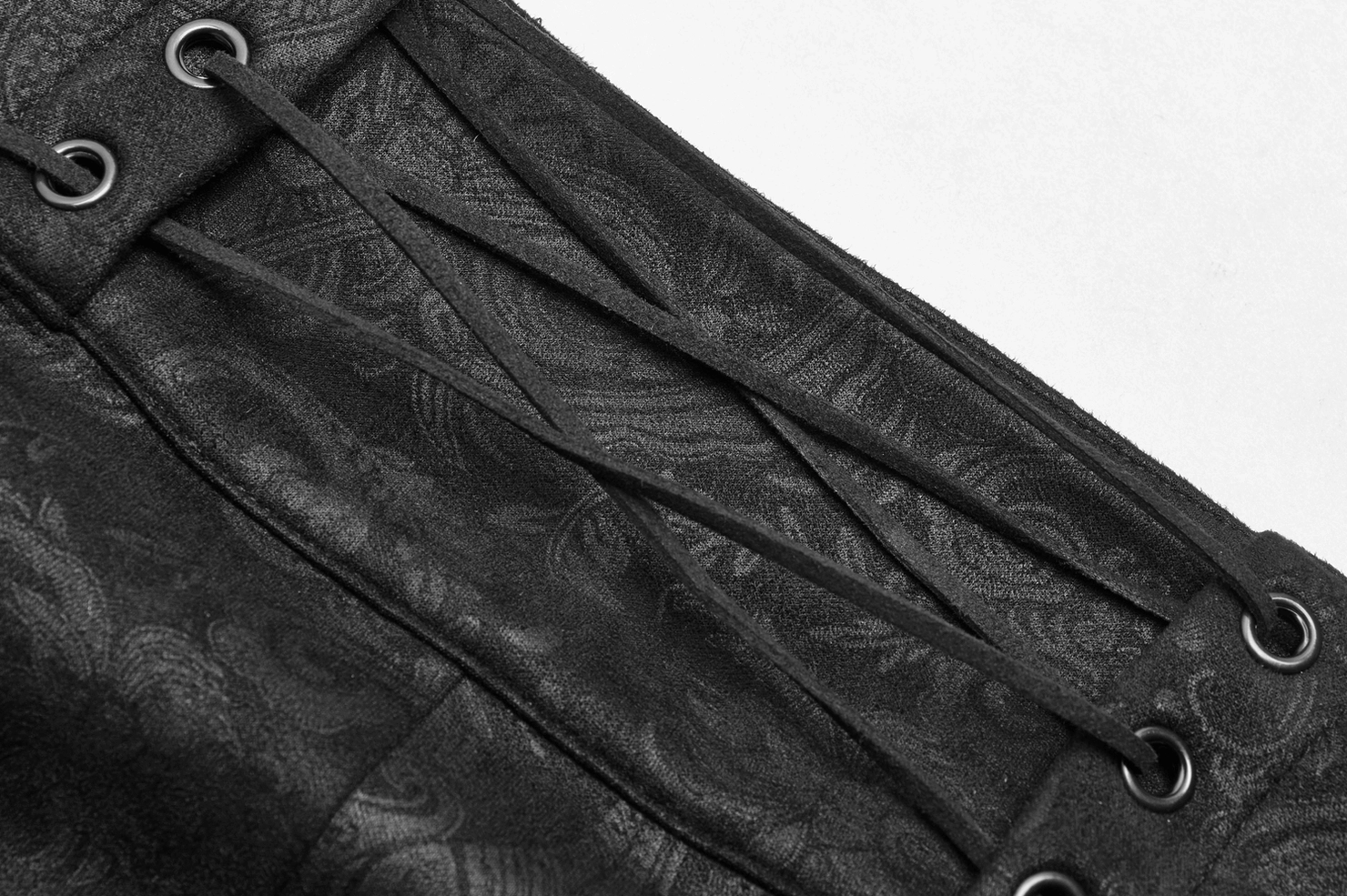 Close-up of gothic overskirt waist lacing with metal eyelets and damask texture