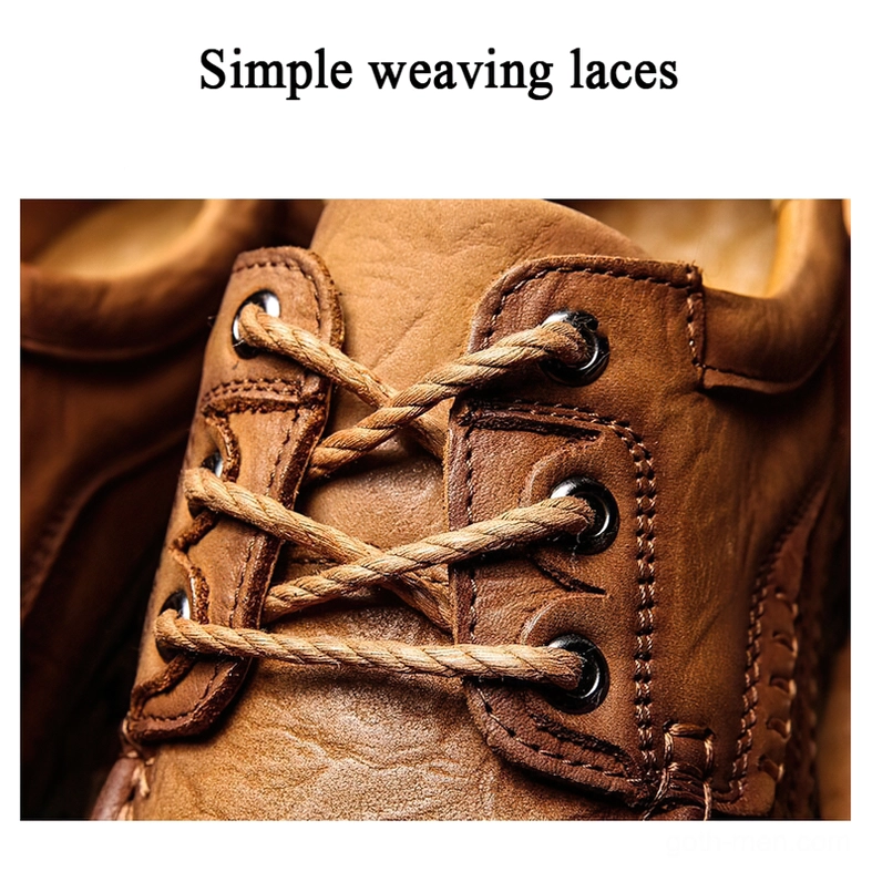 Close-up of metal eyelet fasteners and woven laces on gothic oxford shoe