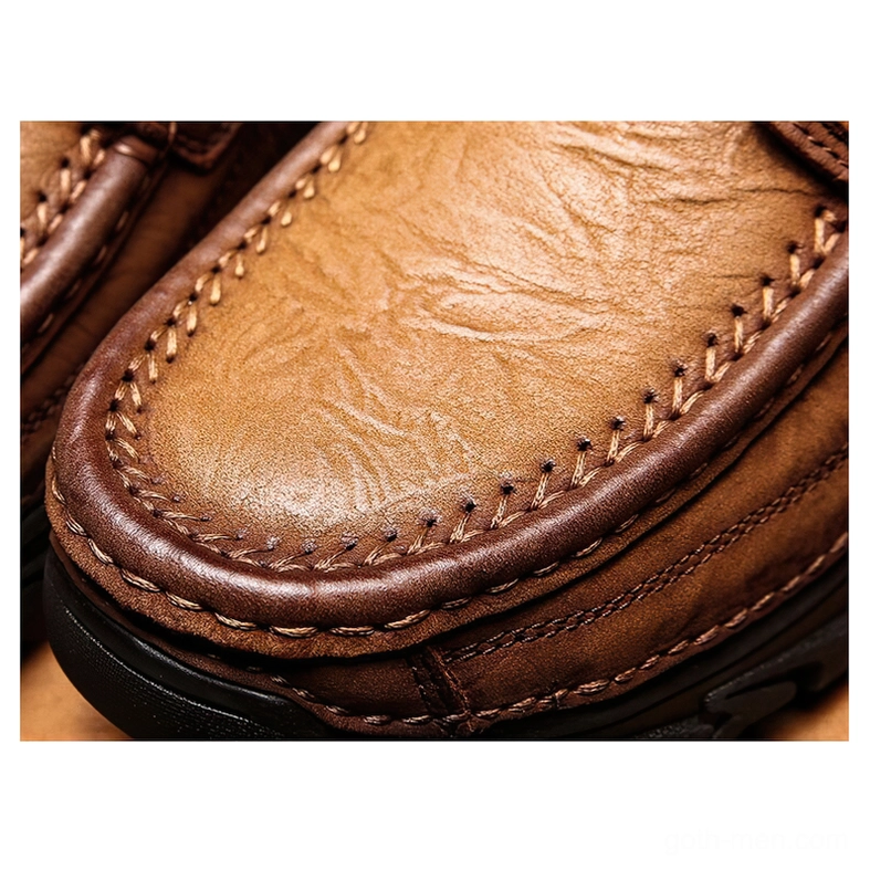 Close-up of leather toe cap with whipstitching and layered panels on gothic oxford