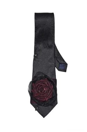 Black paisley gothic necktie flat lay showing 3D burgundy rose ornament and metal snap fasteners, front view against white background