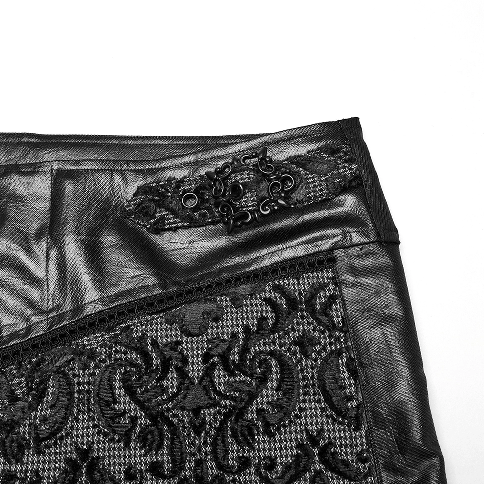 Close-up of ornate metal buckle and lace trim detail on adjustable waist strap of gothic trousers
