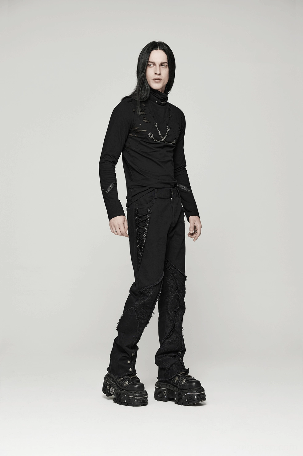 Close-up of ankle button reinforcement and leg opening on fitted black gothic pants