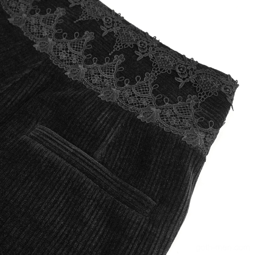 Close-up detail of black corduroy pants back pocket and lace waistband construction
