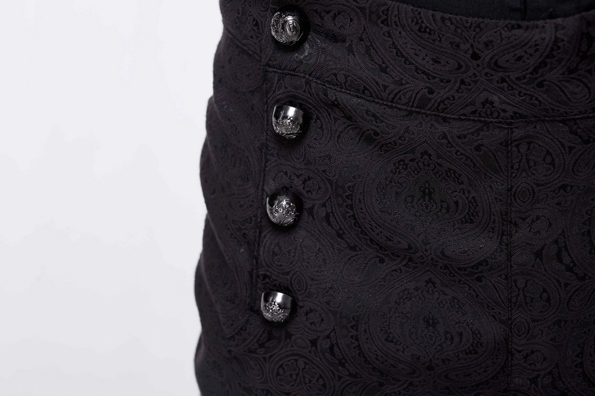 Close-up detail of gothic pants showing four black decorative buttons and paisley jacquard fabric texture