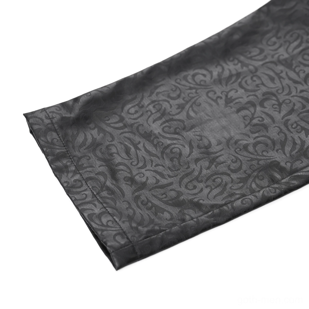 Detailed macro shot of black gothic pants hem cuff, revealing clear embossed damask pattern and faux leather craftsmanship