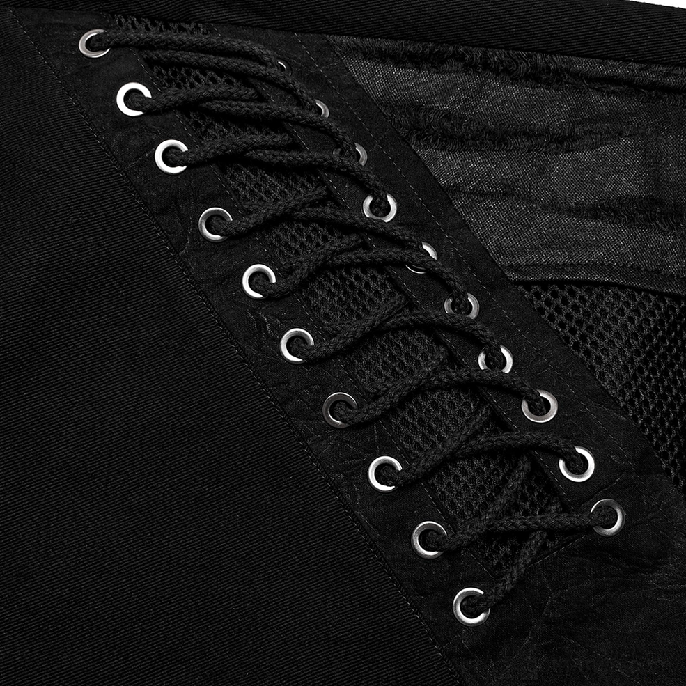 Close-up detailed shot of black lace with metal eyelets and mesh fabric construction