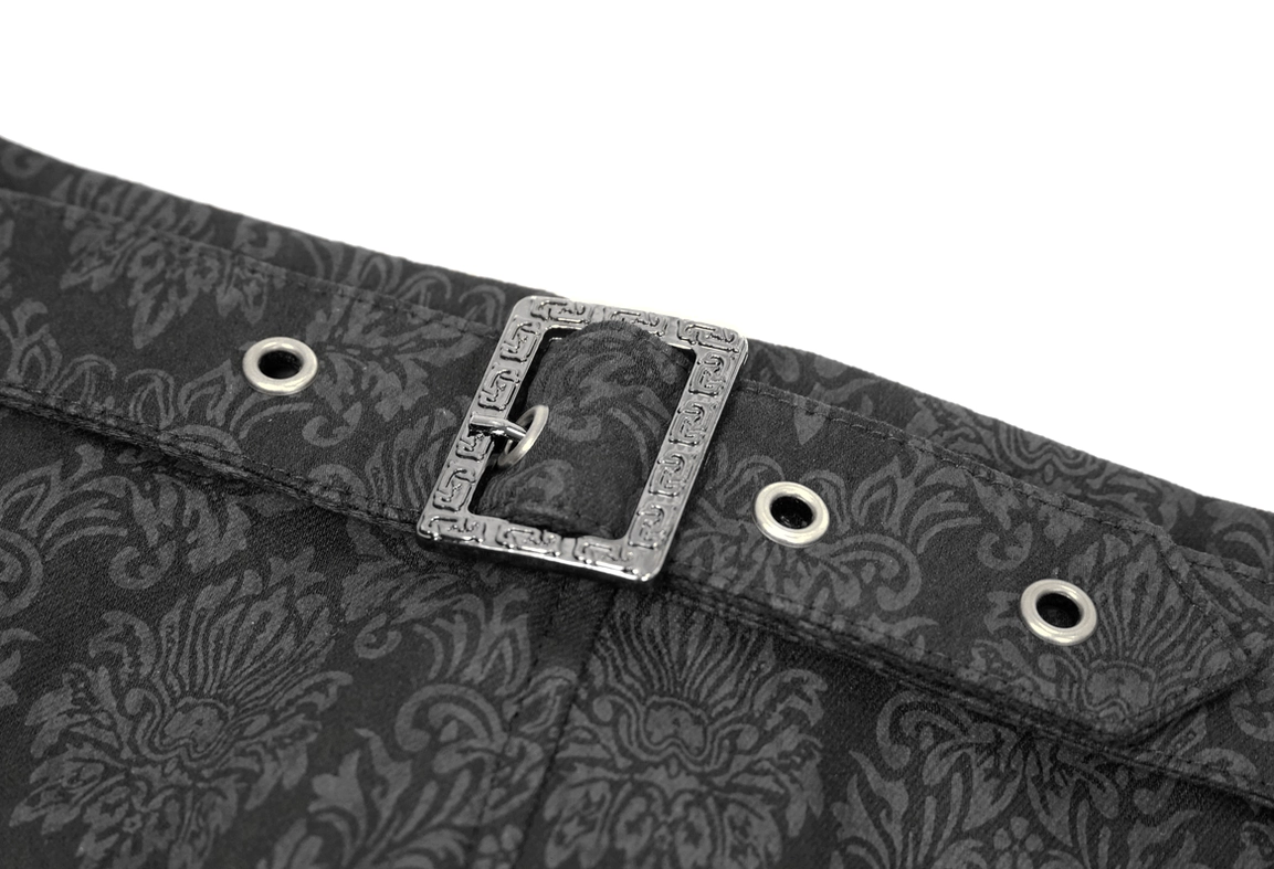 Close-up of black gothic pants waist belt, vintage metal buckle detail with embossed finish on jacquard fabric background
