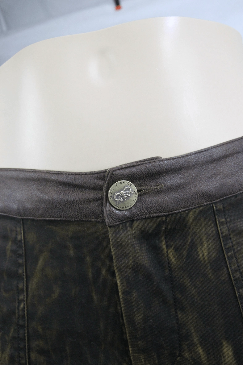 Gothic pencil pants front waist detail showing embossed metal button and faded brown washed cotton-spandex blend fabric