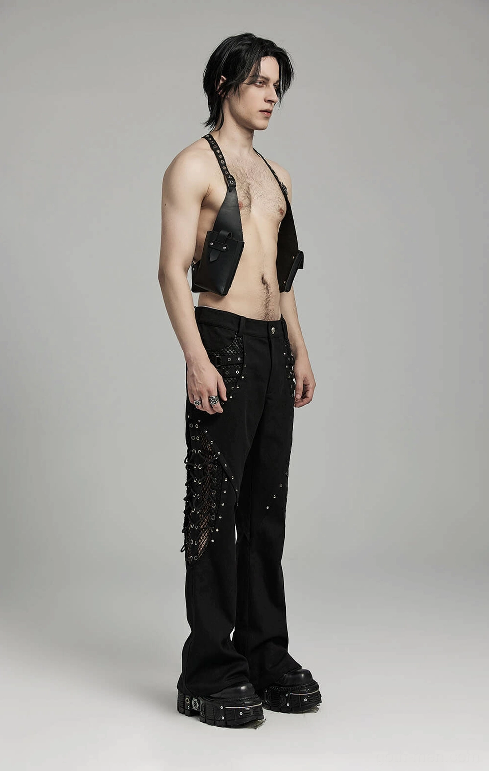 Multi-fabric construction showing leather mesh and twill blend on gothic pants