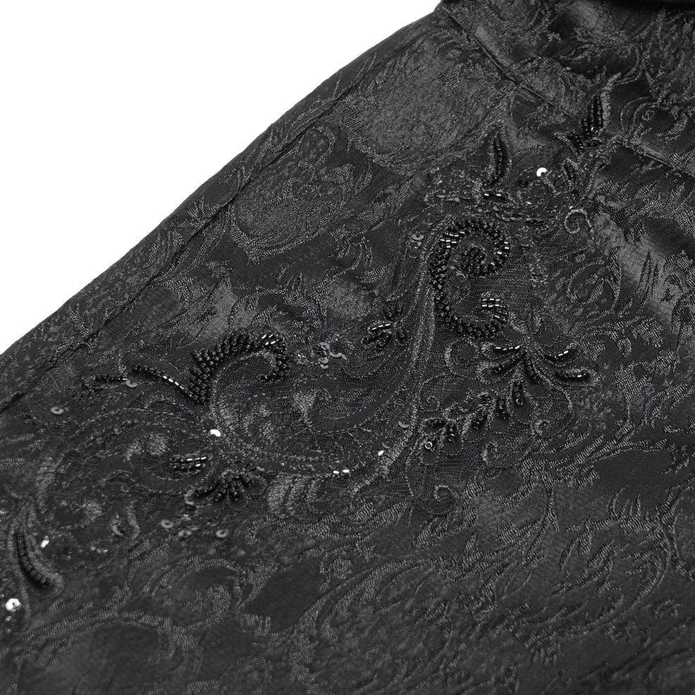 Close-up texture of black paisley jacquard fabric - showing ornate brocade weave with beaded sequin embellishment