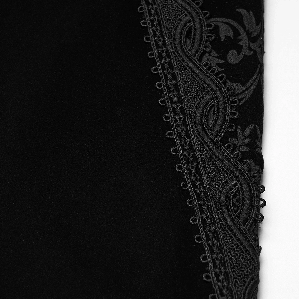 Detailed close-up of black velvet gothic pants ornate paisley lace trim showing tonal design and decorative stitching