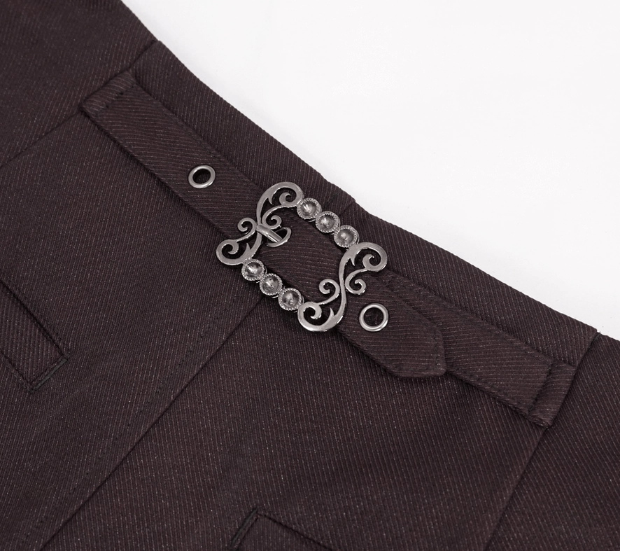 Close-up detail of vintage metal scroll buckle hardware on rear waistband of gothic pants with belt loops