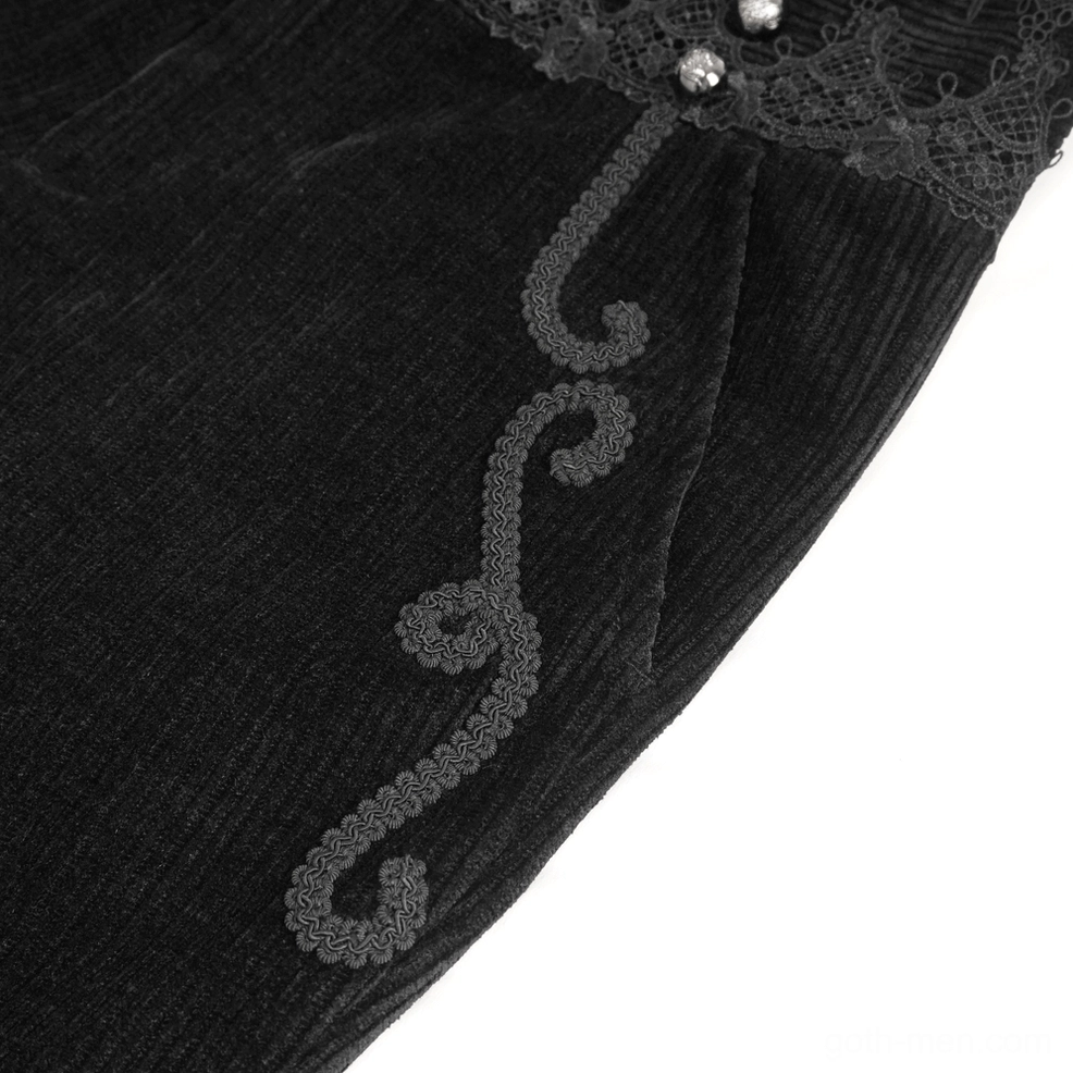 Detailed view of black corduroy pants side seam scroll embroidery and lace waist trim