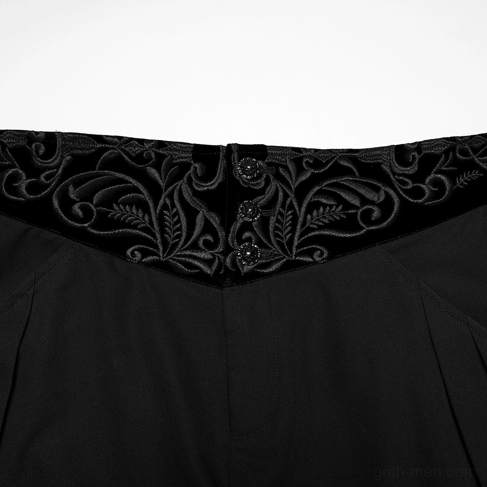 Close-up detail of velvet embroidered waistband on black gothic pants with button closure