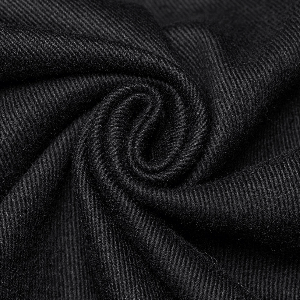 Industrial metal chain and eyelet hardware detail on black gothic pants waistband - close-up
