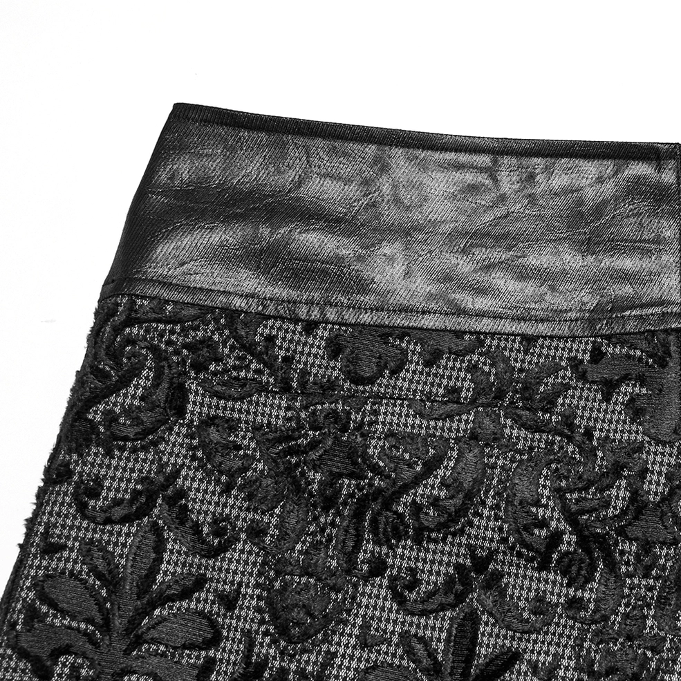 Close-up detail of gothic pants waist showing leather stitching and embroidered lace fabric composition