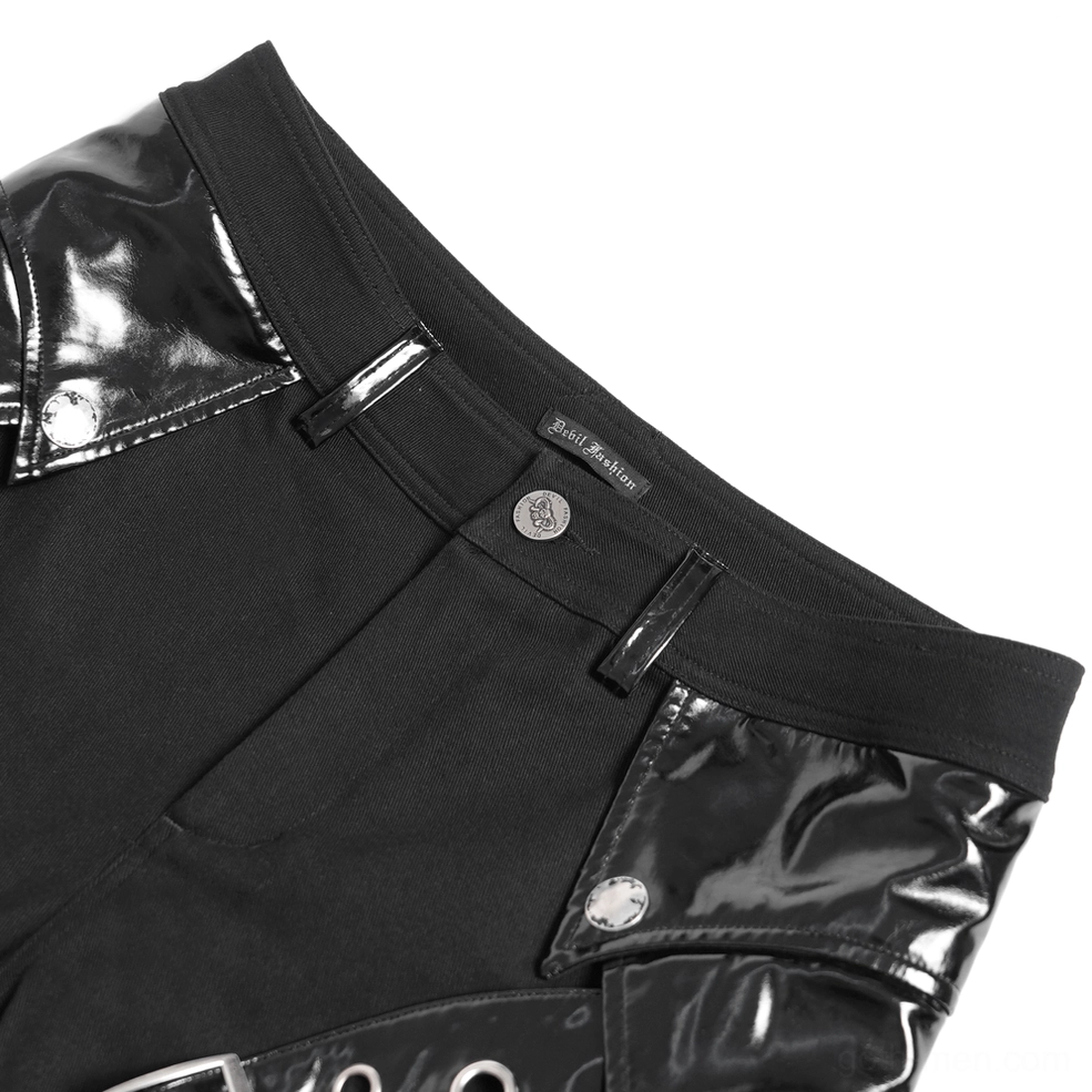 Close-up detail of black gothic pants waist area showing patent leather panels and metal snap buttons