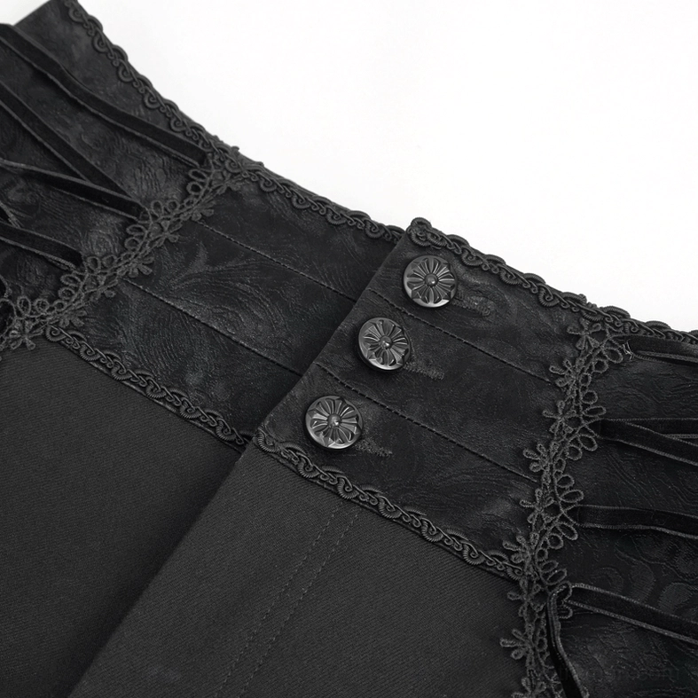 Close-up detail of gothic trousers waist front featuring vintage metal patterned buttons and embroidered lace trim