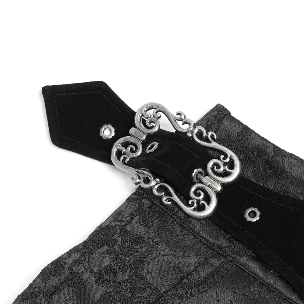 Close-up detail of gothic pants waistband showing silver floral embroidery and velvet trim accent
