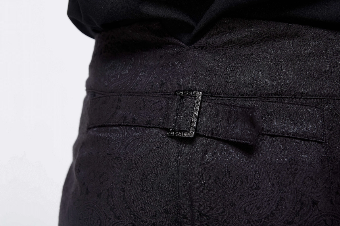 Close-up of vintage gothic black pants waist featuring leather belt loop adjuster and decorative paisley weave pattern