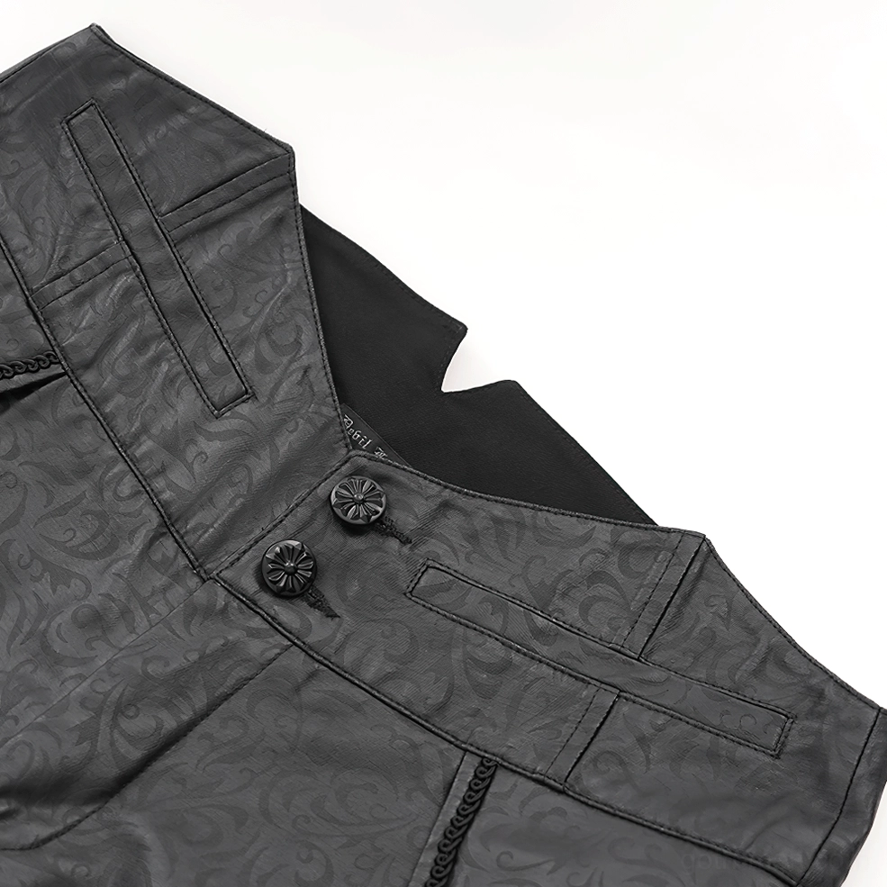Close-up detail of black leather gothic pants waistband, showing ornate metal button fasteners and embossed surface